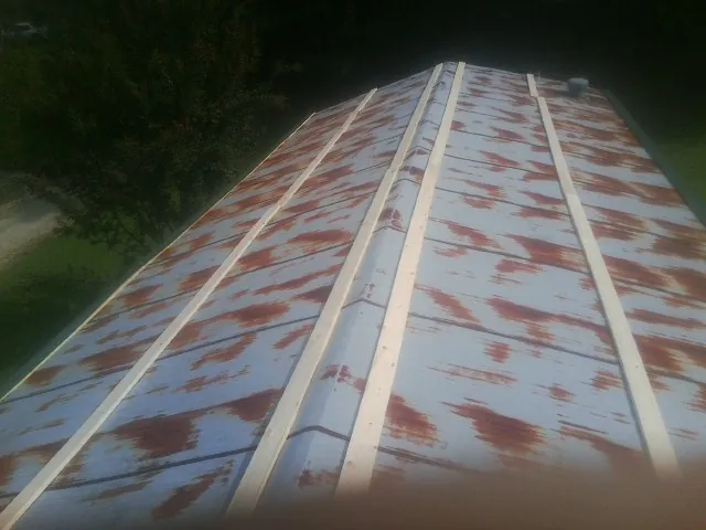 Rusted metal roof panels with new wood purlins before replacement — Storm Damage Roof Repair in Sevierville by Roofing Brothers