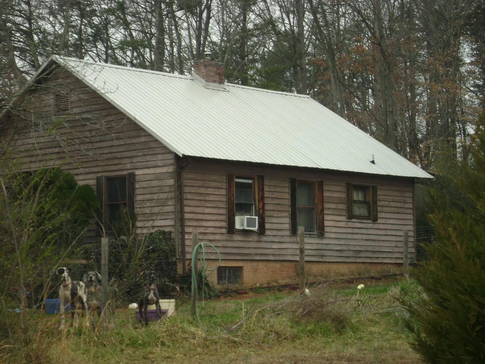 White metal roof on an old wood sided farmhouse, from a Metal Roof Installation job in Sevierville